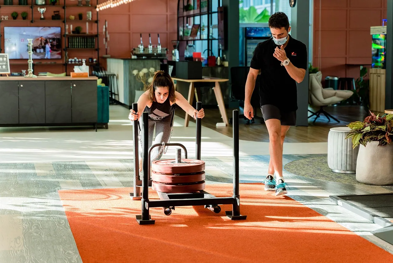 Coach guiding a sled push.