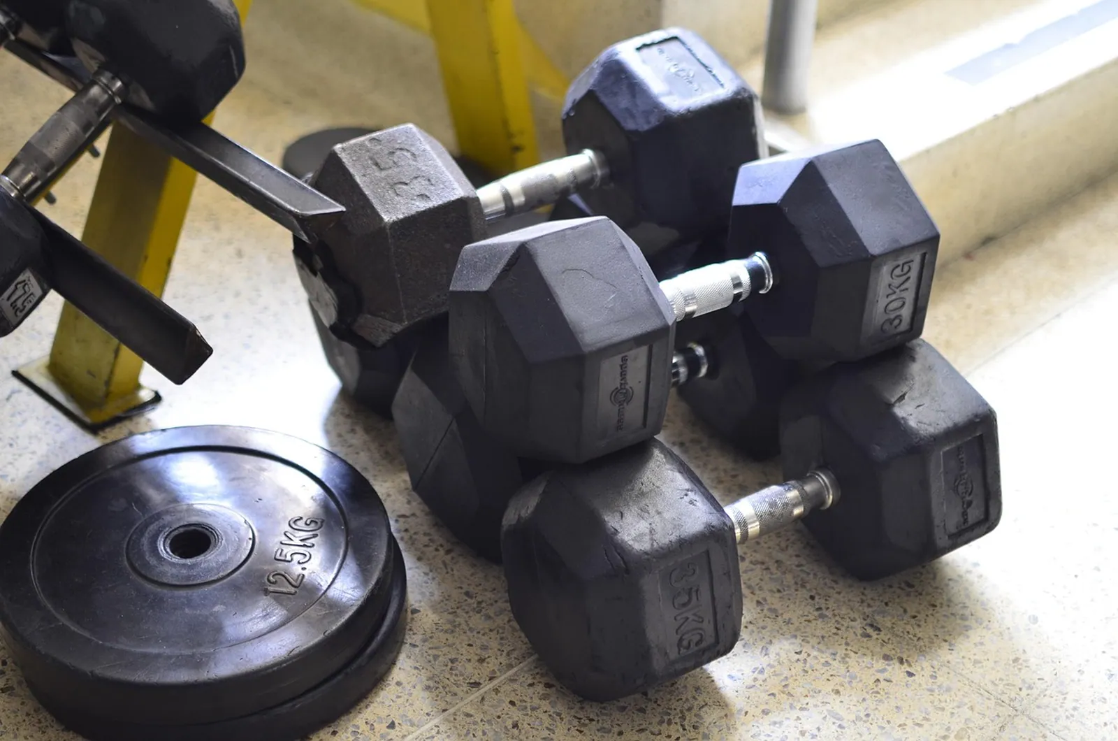 Hex dumbbells racked on the gym floor.