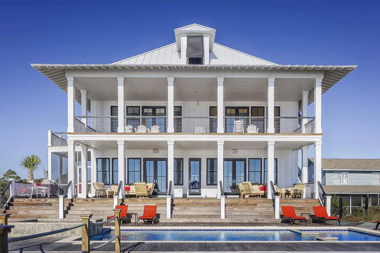 A large white house with a swimming pool.