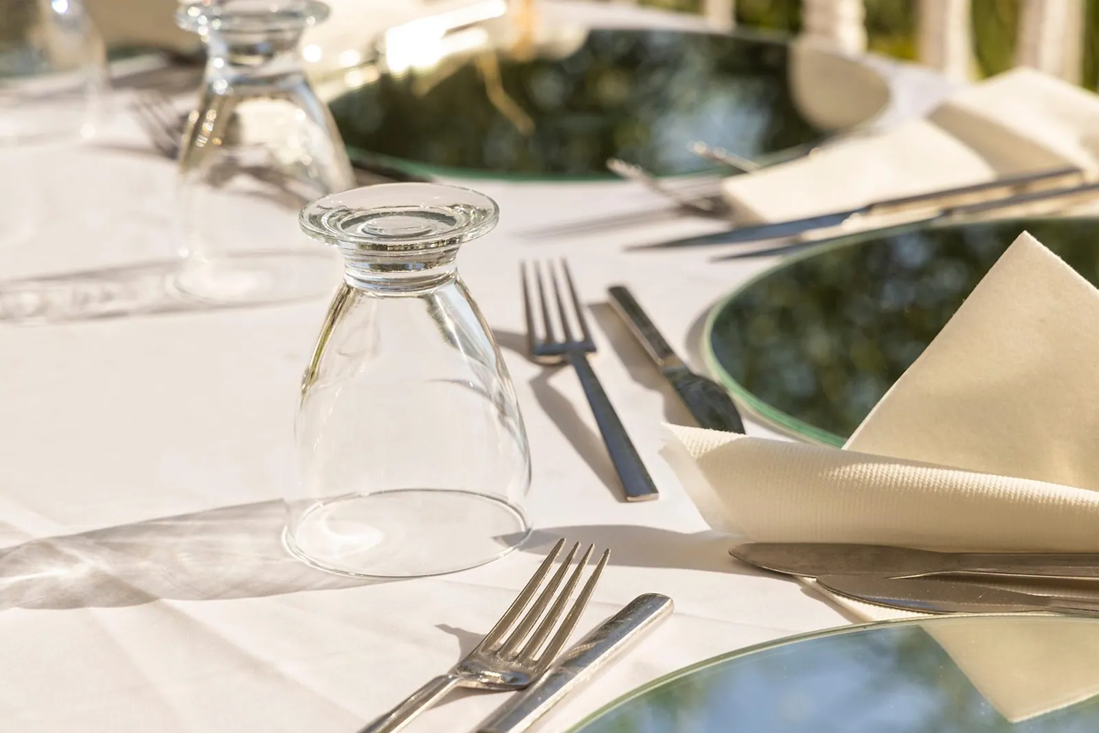 A table laid with plates and glasses in the Casa Verde dining room.