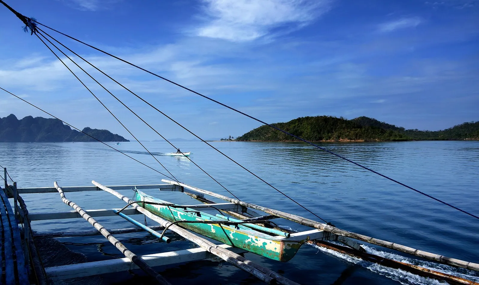 Boats moored beside an island.